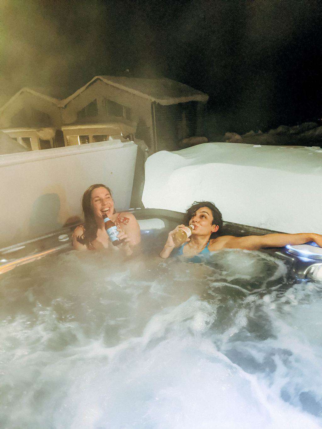 Two women enjoying a beer in a jacuzzi Finnish Lapland, Lapland destinations, Lapland Finland, Inghams
