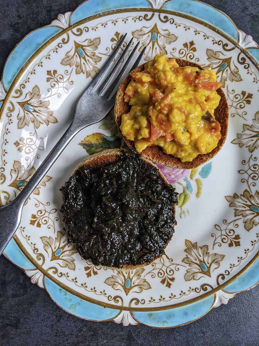 A plate with two muffins, one with scrambled eggs and one with laverbread