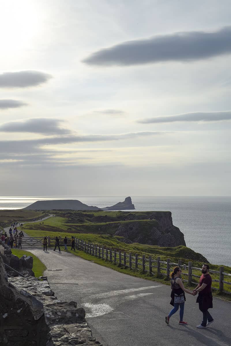 A tarmac path leading to a cliff top